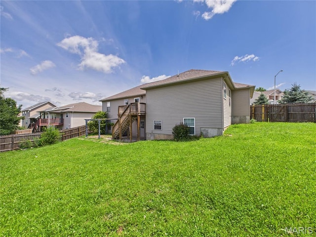 16107 Hummingbird Ln, Saint Robert, MO 65584 - rear view of house with stairway, a fenced backyard, and a deck