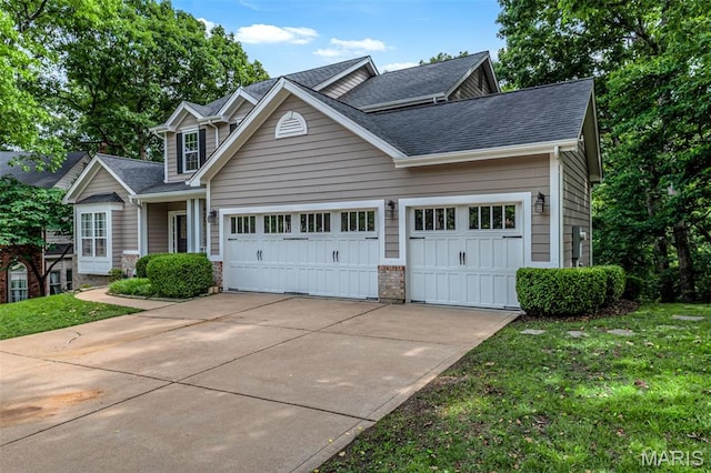 408 Bluff Meadow Dr, Ellisville, MO 63021 - traditional-style home with an attached garage, concrete driveway, roof with shingles, and a front lawn