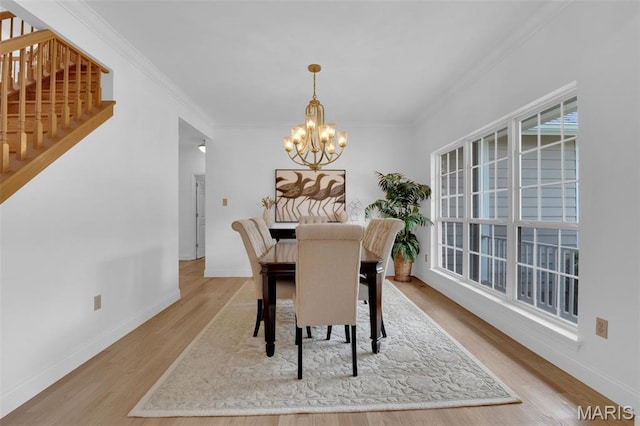 408 Bluff Meadow Dr, Ellisville, MO 63021 - dining room featuring a chandelier, wood finished floors, crown molding, and stairs