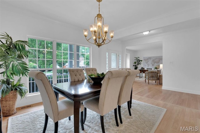 408 Bluff Meadow Dr, Ellisville, MO 63021 - dining area featuring a chandelier, light wood-type flooring, and ornamental molding