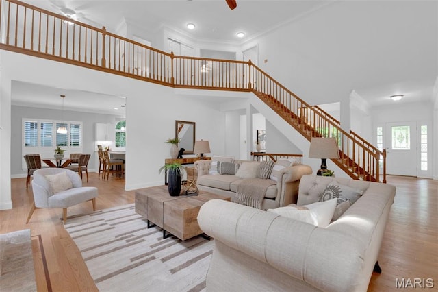 408 Bluff Meadow Dr, Ellisville, MO 63021 - living room with stairway, a high ceiling, wood finished floors, recessed lighting, and ornamental molding