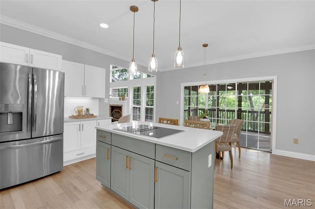 408 Bluff Meadow Dr, Ellisville, MO 63021 - kitchen featuring stainless steel fridge, black electric cooktop, light wood-style floors, white cabinets, and light countertops