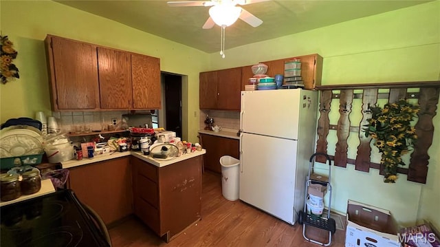 812 S Mine Ln, Motte, Fredericktown, MO 63645 - kitchen featuring freestanding refrigerator, a peninsula, ceiling fan, wood finished floors, and electric range
