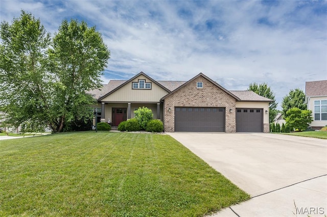3841 Ember Ct, Edwardsville, IL 62025 - craftsman house with a garage, brick siding, a front yard, driveway, and covered porch