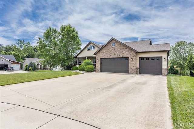 3841 Ember Ct, Edwardsville, IL 62025 - view of front of property featuring brick siding, an attached garage, a front yard, and driveway