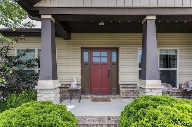 3841 Ember Ct, Edwardsville, IL 62025 - entrance to property with covered porch, stone siding, and board and batten siding