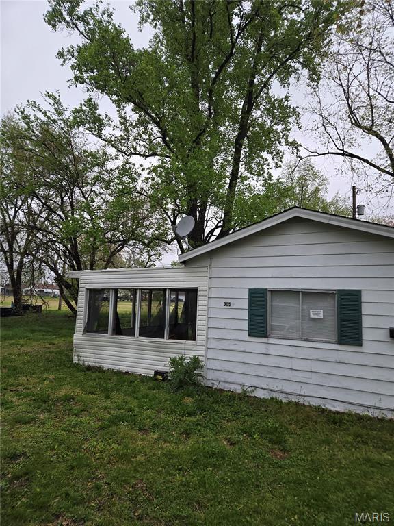 305 W 7th St, Cahokia, IL 62206 - view of side of home featuring a lawn