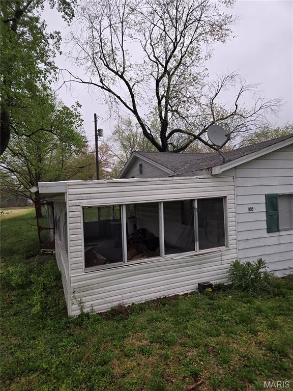 305 W 7th St, Cahokia, IL 62206 - view of home's exterior featuring a sunroom and a yard