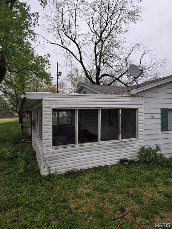 305 W 7th St, Cahokia, IL 62206 - view of property exterior featuring a sunroom and a lawn