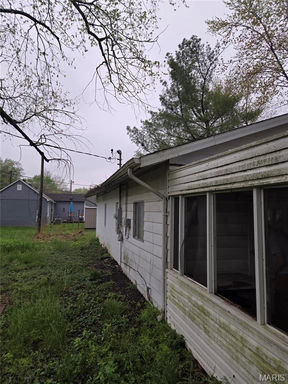 305 W 7th St, Cahokia, IL 62206 - view of home's exterior with a sunroom