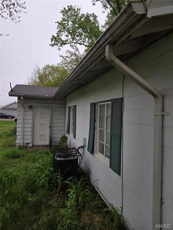 305 W 7th St, Cahokia, IL 62206 - view of property exterior with concrete block siding and a cooling unit
