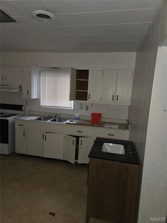305 W 7th St, Cahokia, IL 62206 - kitchen with white electric range, under cabinet range hood, white cabinetry, open shelves, and a drop ceiling