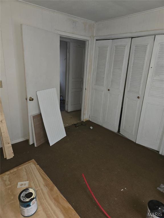 305 W 7th St, Cahokia, IL 62206 - unfurnished bedroom featuring a closet, crown molding, and dark carpet