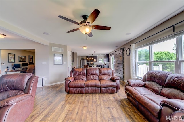 606 Wyndview Dr, Lake St Louis, MO 63367 - living room featuring wood finished floors, a ceiling fan, and a desk