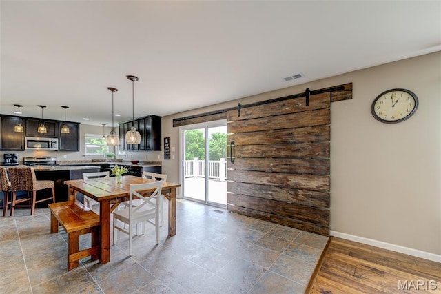 606 Wyndview Dr, Lake St Louis, MO 63367 - dining area with baseboards and a barn door