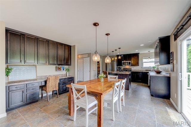606 Wyndview Dr, Lake St Louis, MO 63367 - dining space featuring light stone finish flooring, built in desk, and recessed lighting
