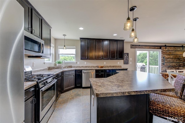 606 Wyndview Dr, Lake St Louis, MO 63367 - kitchen with appliances with stainless steel finishes, healthy amount of natural light, a kitchen island, decorative light fixtures, and recessed lighting