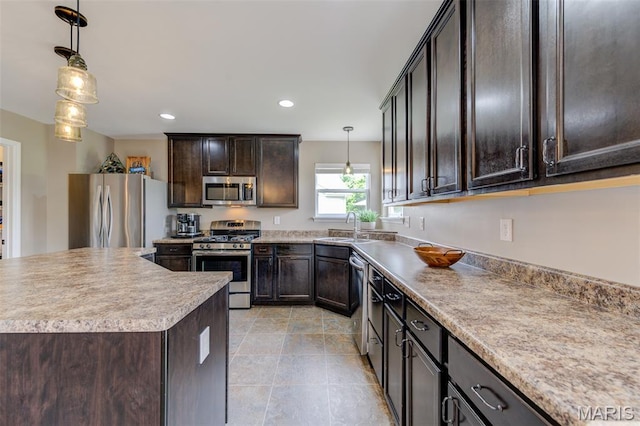 606 Wyndview Dr, Lake St Louis, MO 63367 - kitchen with appliances with stainless steel finishes, dark brown cabinetry, hanging light fixtures, light countertops, and recessed lighting