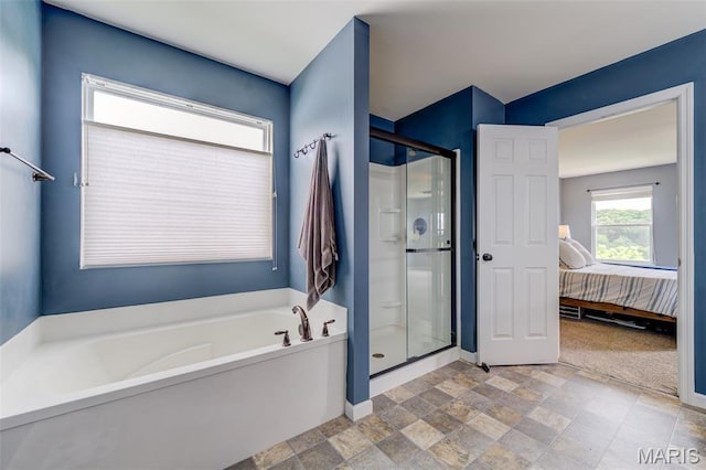 606 Wyndview Dr, Lake St Louis, MO 63367 - ensuite bathroom featuring a bath, a stall shower, and stone finish floors