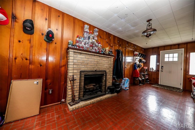2909 Grand Ave, Granite City, IL 62040 - living area with brick patterned flooring, wooden walls, and a fireplace