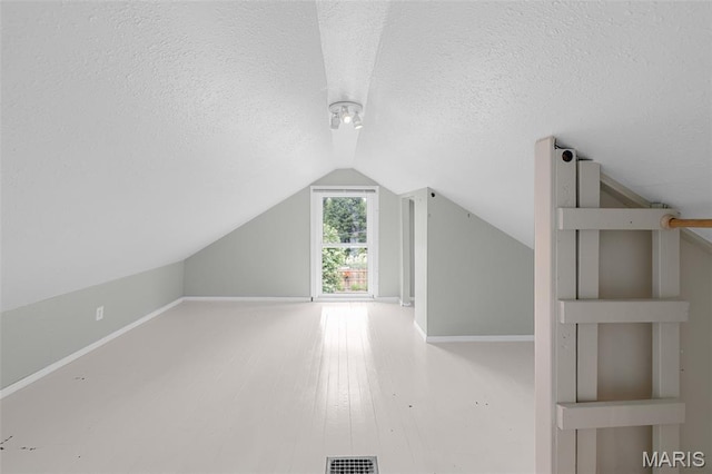 3119 Tamm Ave, Saint Louis, MO 63139 - additional living space with a textured ceiling and lofted ceiling