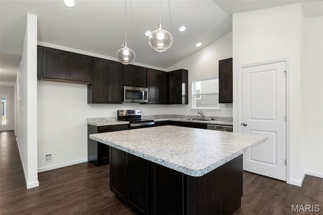 4939 Knotty Alder Dr, Imperial, MO 63052 - kitchen with appliances with stainless steel finishes, a center island, light countertops, dark wood finished floors, and recessed lighting