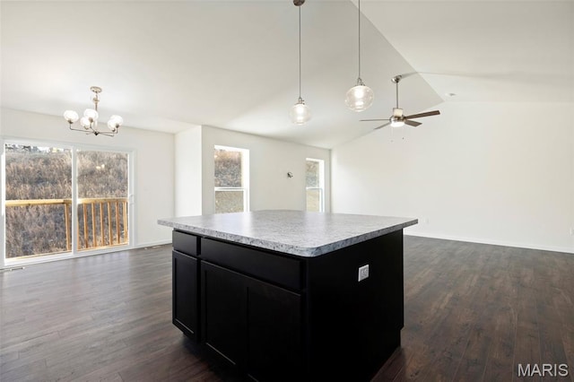 4939 Knotty Alder Dr, Imperial, MO 63052 - kitchen with dark cabinetry, lofted ceiling, open floor plan, a chandelier, and dark wood finished floors