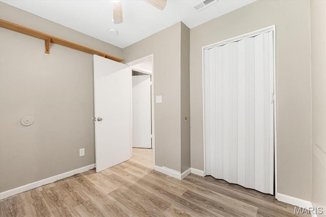 12 Mcnulty Dr, Florissant, MO 63031 - unfurnished bedroom with light wood-style flooring, a closet, and a ceiling fan