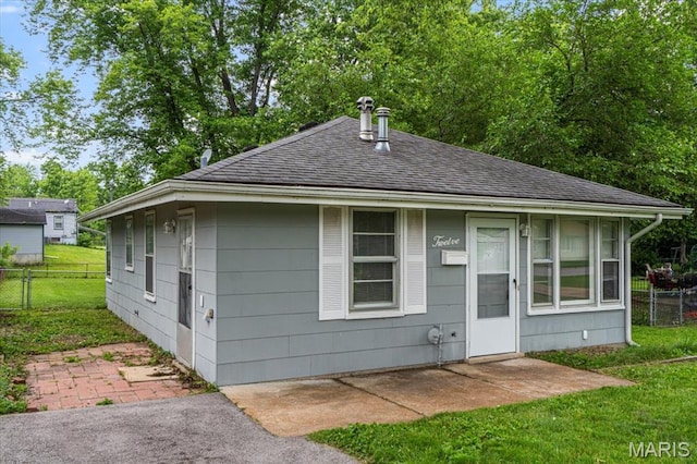 12 Mcnulty Dr, Florissant, MO 63031 - bungalow-style home featuring roof with shingles and a patio area