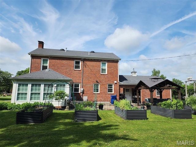 402 S Walker St, Montgomery City, MO 63361 - back of property featuring a vegetable garden, a chimney, and brick siding