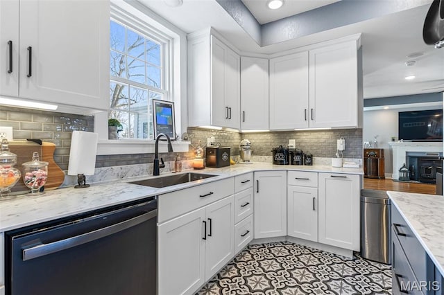 402 S Walker St, Montgomery City, MO 63361 - kitchen featuring dishwashing machine, white cabinets, tasteful backsplash, and light stone counters