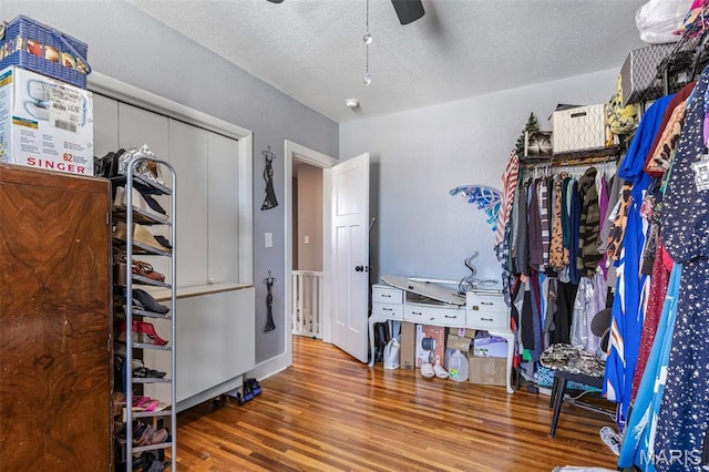402 S Walker St, Montgomery City, MO 63361 - bedroom with a textured ceiling, wood finished floors, ceiling fan, and a closet