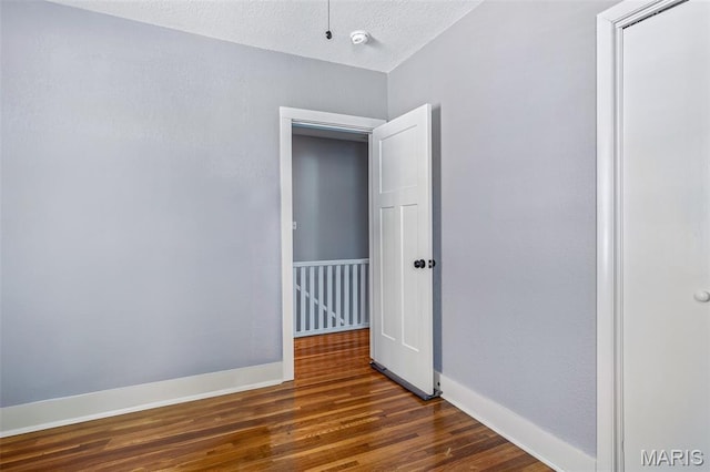 402 S Walker St, Montgomery City, MO 63361 - unfurnished room with dark wood finished floors and a smoke detector