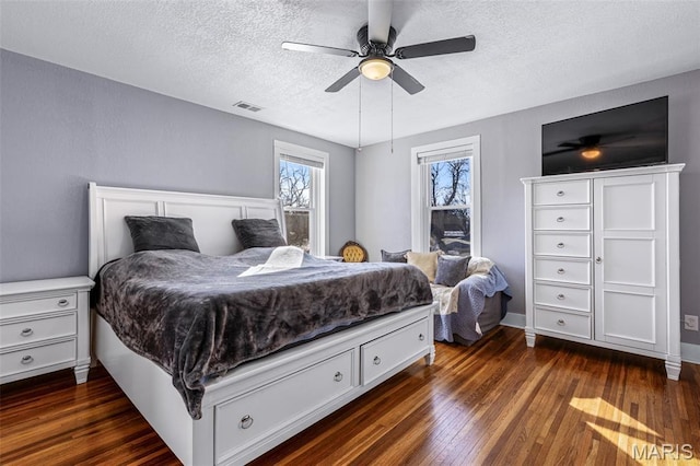 402 S Walker St, Montgomery City, MO 63361 - bedroom with dark wood finished floors, a textured ceiling, and ceiling fan