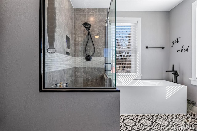 402 S Walker St, Montgomery City, MO 63361 - bathroom with tiled shower, a freestanding tub, and tile patterned floors