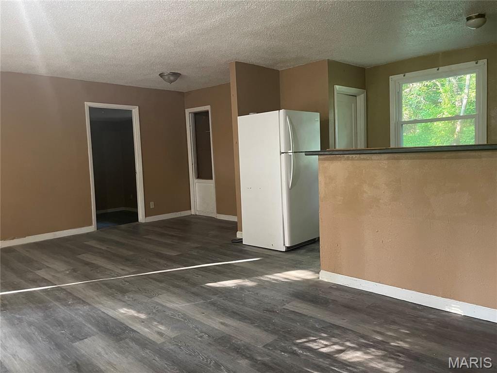 38 Westdell Dr, Dellwood, MO 63136 - kitchen with freestanding refrigerator, a textured ceiling, and wood finished floors