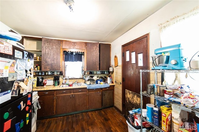 129 Maple Ave, Licking, MO 65542 - kitchen with open shelves, freestanding refrigerator, dark wood finished floors, light countertops, and dark brown cabinetry