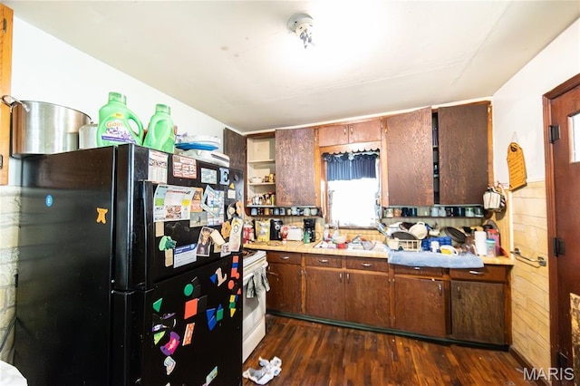 129 Maple Ave, Licking, MO 65542 - kitchen with freestanding refrigerator, light countertops, dark wood-style floors, and white stove