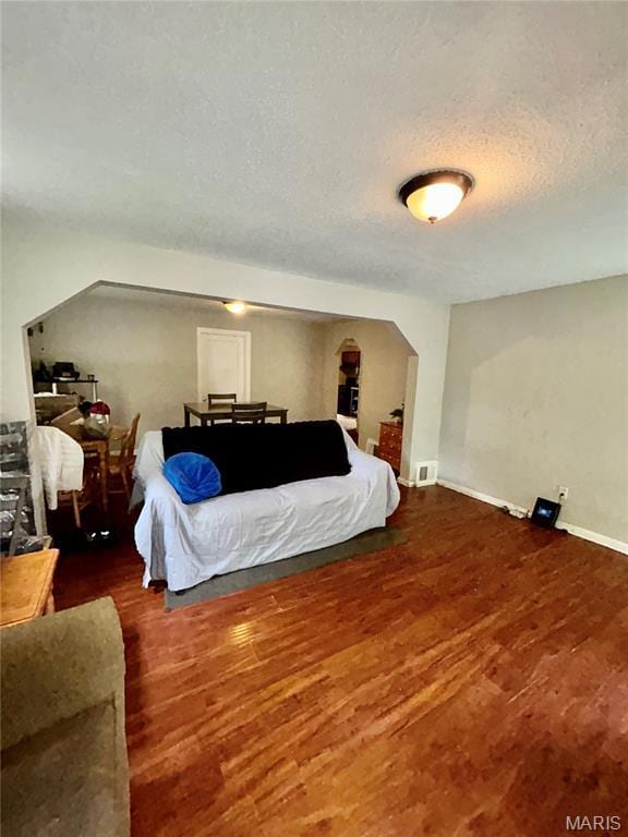7155 Theodore Ave, Jennings, MO 63136 - bedroom with wood finished floors and a textured ceiling
