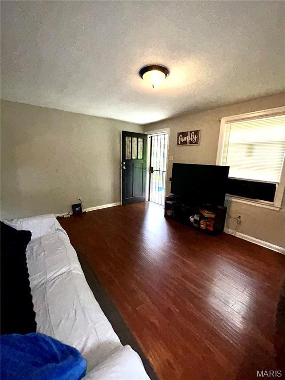7155 Theodore Ave, Jennings, MO 63136 - bedroom featuring wood finished floors and a textured ceiling