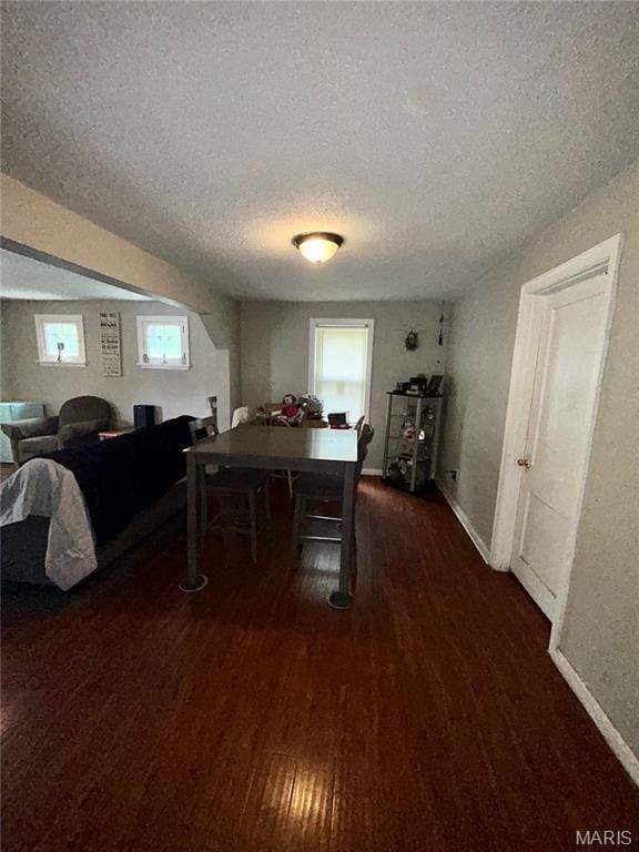 7155 Theodore Ave, Jennings, MO 63136 - dining room featuring a textured ceiling and wood finished floors
