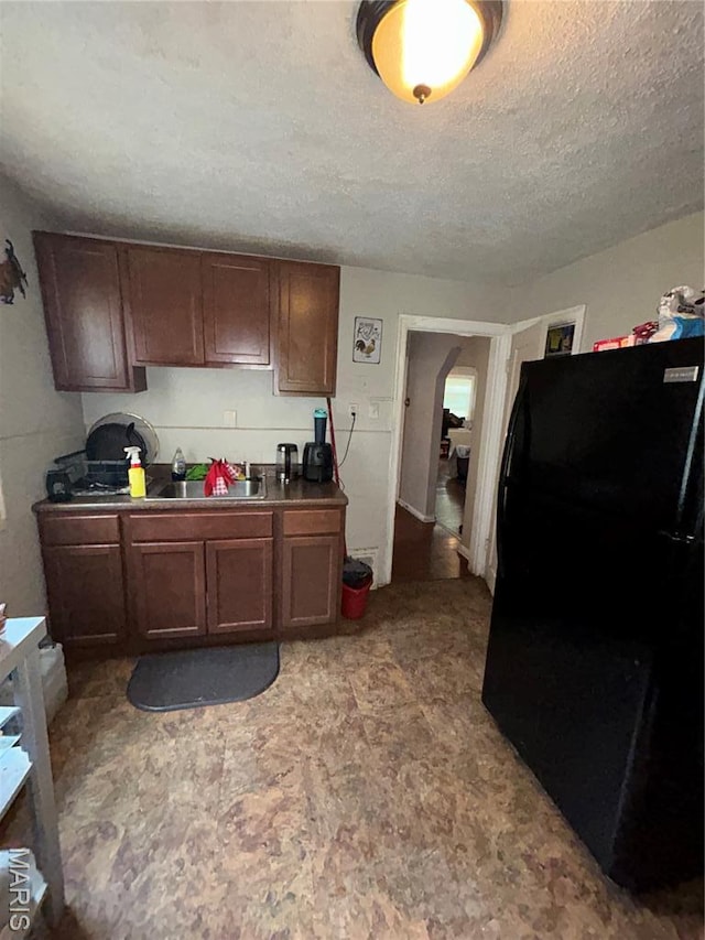 7155 Theodore Ave, Jennings, MO 63136 - kitchen featuring freestanding refrigerator and a textured ceiling