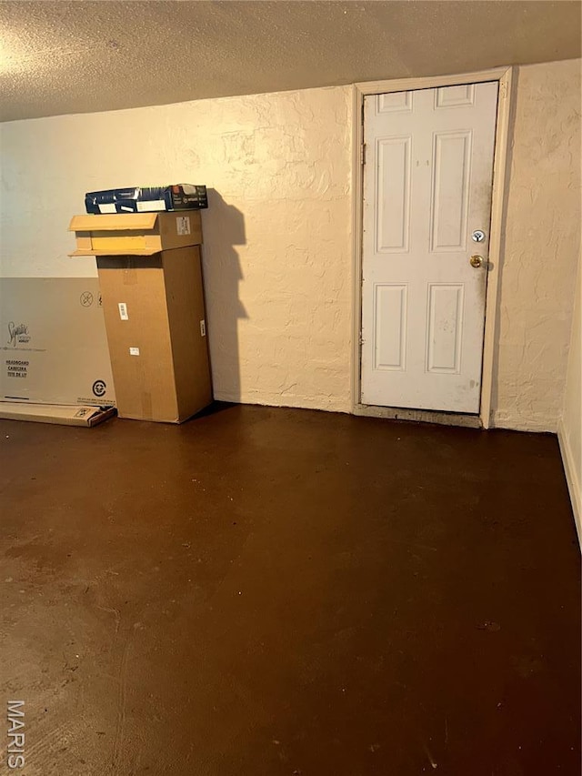 7155 Theodore Ave, Jennings, MO 63136 - spare room featuring a textured wall, concrete floors, and a textured ceiling