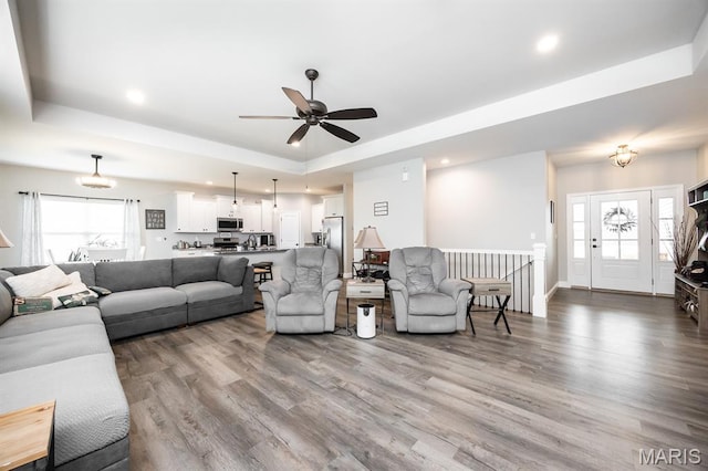 812 Green Jacket Way, Ofallon, IL 62269 - living room with a raised ceiling, ceiling fan, wood finished floors, plenty of natural light, and recessed lighting