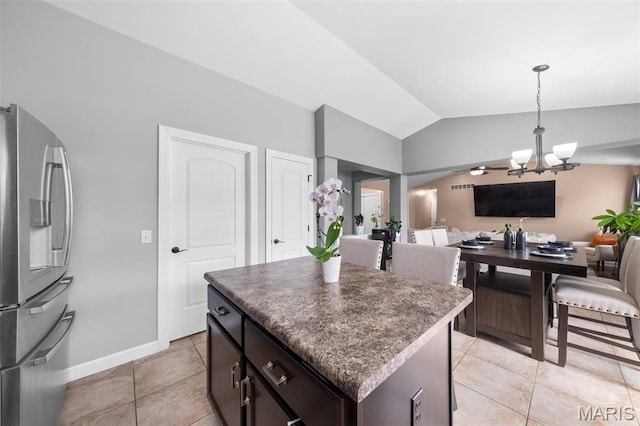 80 Brookshire Creek Dr, Wentzville, MO 63385 - kitchen with freestanding refrigerator, lofted ceiling, a chandelier, dark countertops, and light tile patterned floors