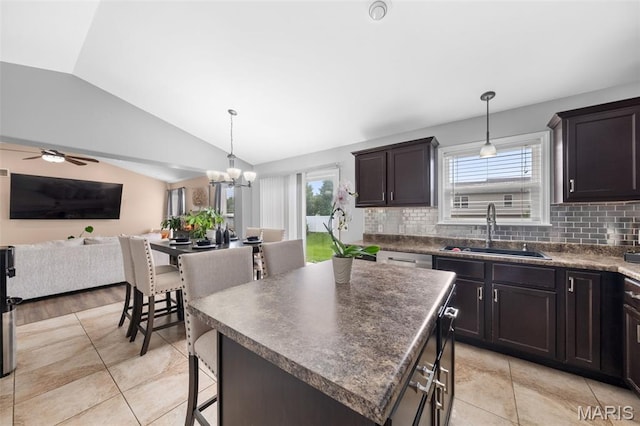 80 Brookshire Creek Dr, Wentzville, MO 63385 - kitchen featuring vaulted ceiling, open floor plan, dark countertops, decorative backsplash, and light tile patterned floors