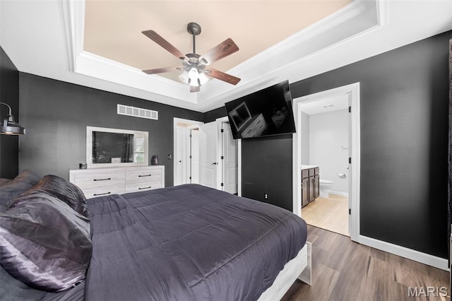 80 Brookshire Creek Dr, Wentzville, MO 63385 - bedroom with a tray ceiling, wood finished floors, connected bathroom, and ceiling fan