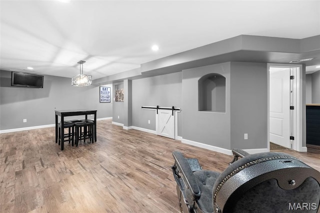 80 Brookshire Creek Dr, Wentzville, MO 63385 - exercise room with light wood-style floors, a barn door, and recessed lighting