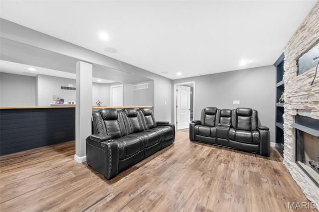 80 Brookshire Creek Dr, Wentzville, MO 63385 - living room featuring a dry bar, wood finished floors, a fireplace, built in shelves, and recessed lighting