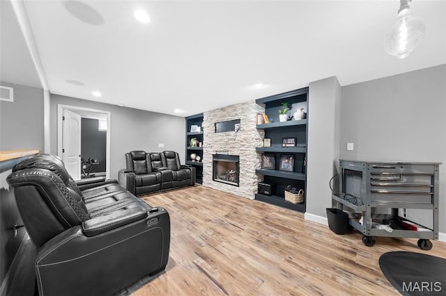 80 Brookshire Creek Dr, Wentzville, MO 63385 - living room with light wood-type flooring, built in features, a stone fireplace, and recessed lighting